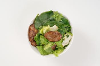 bowl of pan fried chicken liver with salad greens