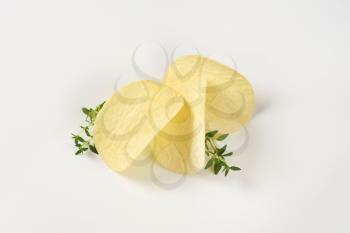 potato chips and thyme on white background