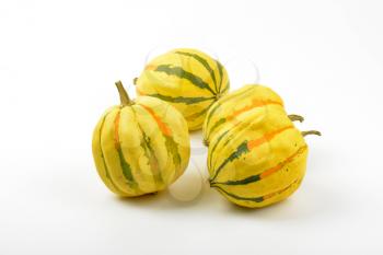 small striped pumpkins on white background
