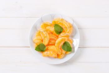 plate of fresh tangerine slices on white background