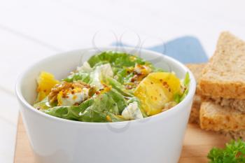 Chinese cabbage salad with orange, walnuts and blue cheese served with bread