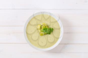 plate of vegetable soup with Brussels sprouts on white background