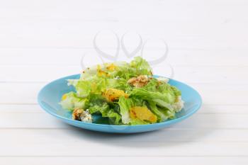 plate of Chinese cabbage salad with orange, walnuts and blue cheese