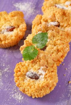 Small almond cookies on purple background