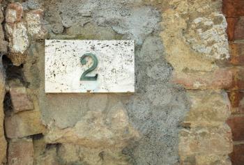 House number on a weathered wall