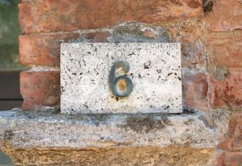 House number on a weathered wall