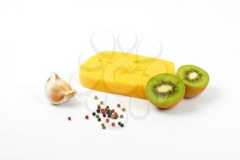 emmental cheese with garlic and kiwi on white background