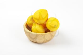 bowl of ripe lemons on white background