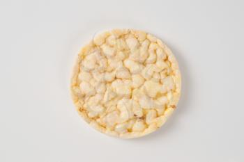 slice of puffed rice bread on white background