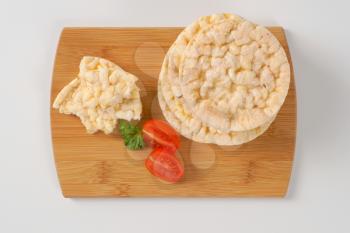 slices of puffed rice bread on wooden cutting board