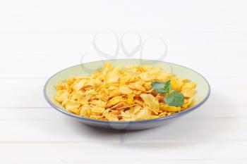 plate of corn flakes on white background