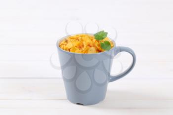cup of corn flakes on white background