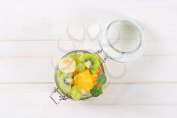 jar of fresh fruit salad on white background