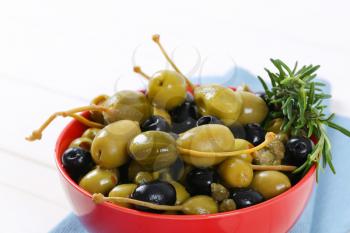 bowl of pickled olives, capers and caper berries