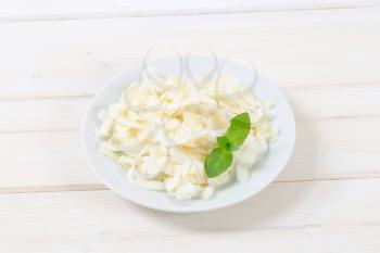 plate of coconut chips on white background
