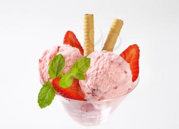 close up of strawberry ice cream and fresh strawberries in cocktail glass