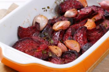 freshly baked beetroot with garlic in baking dish - close up