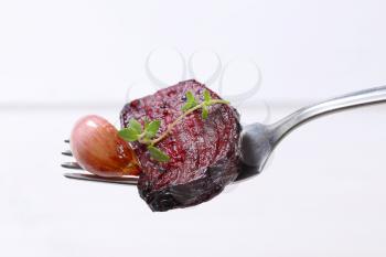 baked beetroot with garlic and thyme on silver fork