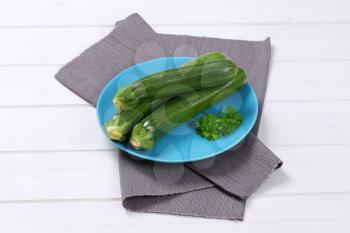 plate of fresh green zucchini on grey place mat