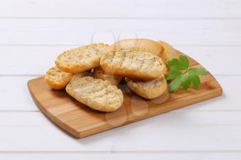 pile of crispy rusks on wooden cutting board