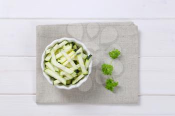 bowl of zucchini strips on beige place mat