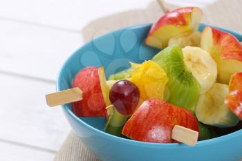 fresh fruit skewers in turquoise bowl - close up