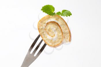 Slice of sweet creamy roll on a fork