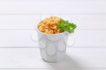 Cooked red lentils in white porcelain cup