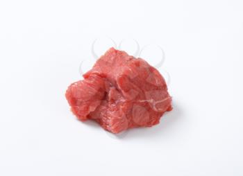 small piece of raw beef meat on white background