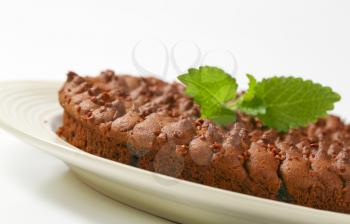 close up of homemade chocolate round cake on white plate