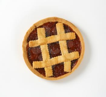 strawberry jam tart with lattice on top on white background