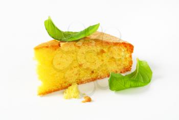 Slice of lemon sponge cake on white background