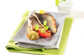 Pan fried fish fillets and vegetable garnish