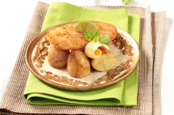 Fried fish fillet served with new potatoes
