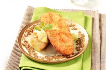 Fried fish fillet served with new potatoes