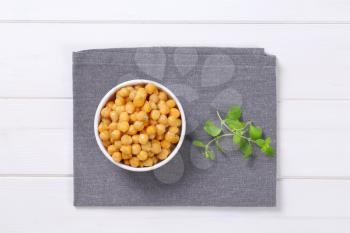 bowl of cooked chickpeas on grey place mat