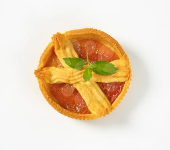 small apricot jam tart on white background
