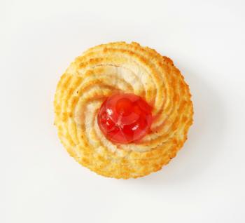 Traditional Sicilian almond cookie topped with glace cherry on white background