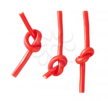 knotted soft strawberry candy sticks on white background