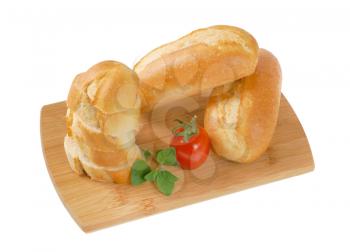whole and sliced mini baguettes on wooden cutting board