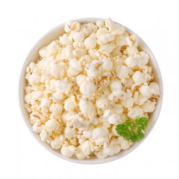 bowl of fresh popcorn on off-white background with shadows