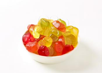 Fruit-shaped gummy candy in white bowl