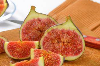 fresh sliced figs on wooden cutting board - close up