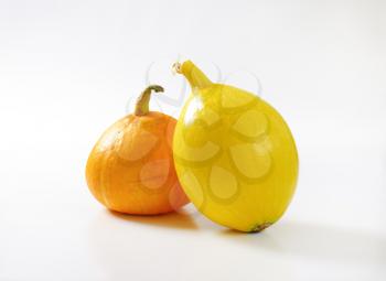 orange and yellow pumpkins on white background