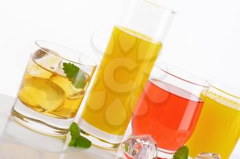 variety of fresh fruit juices on white background - close up