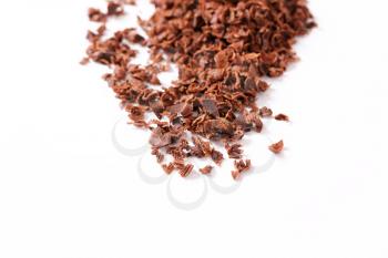 Grated baking chocolate on white background