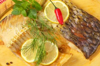 Oven baked carp fillets with lemon and herbs