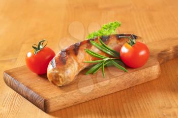 Grilled bratwurst on cutting board