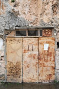Old rusty door in weathered rock