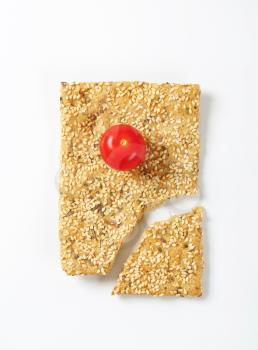 Cherry tomato on sesame seed cracker